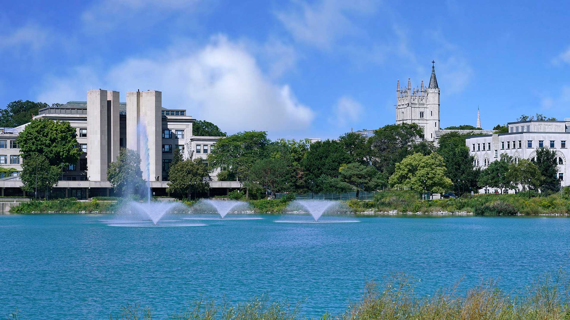 Northwestern University campus buildings and fountains beside the lagoon in Evanston.